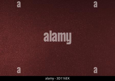 Abstract shiny, radiant texture background with different shades of dark red color. Painted canvas, glitter concrete surface, studio backdrop, grainy Stock Photo