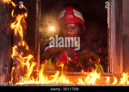 Firefighter rescue child from burning building Stock Photo - Alamy