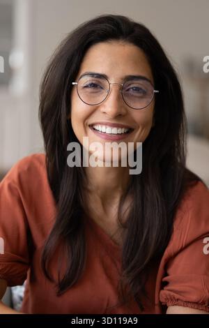 Happy beautiful young Latin woman wearing trendy elegant glasses Stock Photo