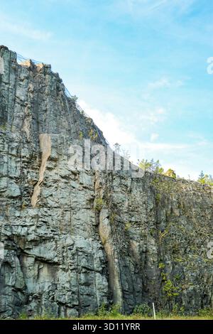 Massive gray rock cliff face with columnar texture Stock Photo