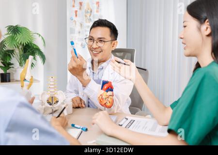 Team of doctors and nurses collaborating in a clinical environment, reviewing treatment options and sharing medical opinions to provide effective pati Stock Photo