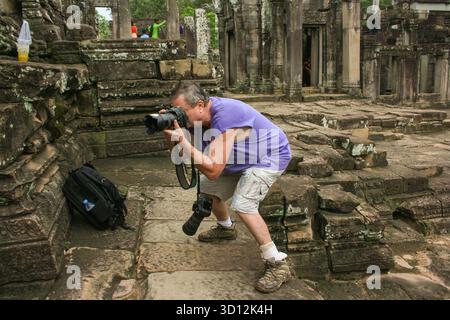 photographer Kraig Lieb in action at The Bayon Temple, Angkor Archaeological Park, Siem Reap Province, Cambodia. © Brooks Lieb Stock Photo