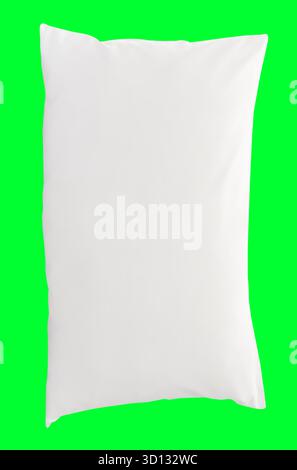 One white pillow after use is isolated on light green background with clipping path. Stock Photo