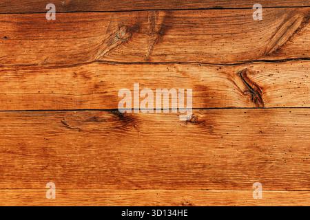 Old natural dark wood planks showing intricate grain patterns and knots, creating a rustic and organic surface texture Stock Photo