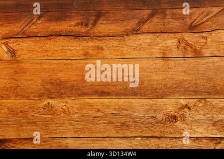 Old natural dark wood planks showing intricate grain patterns and knots, creating a rustic and organic surface texture Stock Photo