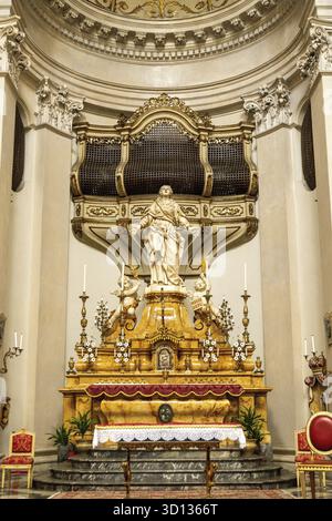 Catania, Sizilien - Italy - 04-15-2025: Ornate altar with large statue and golden details in SantAgata Cathedral, framed by marble walls, candleholder Stock Photo