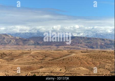 Stunning view of Agafay Desert landscape in Morocco showcasing vast plains and mountains Stock Photo