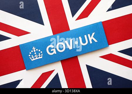 KYIV, UKRAINE - SEPTEMBER 17, 2025 Government GOV UK logotype sticker lies on UK flag close up Stock Photo