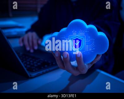 AI-powered cloud computing concept with digital security shield icon in hand. Representing cybersecurity, cloud data protection, artificial intelligen Stock Photo