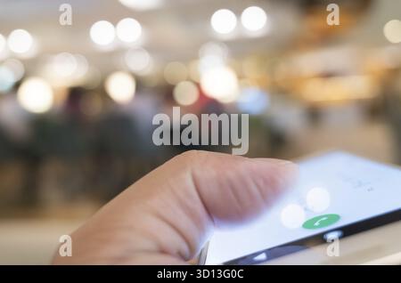 Using cellphone to dial, closeup image focus on the button Stock Photo
