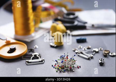 Thimble and sewing pins on dark backdround Stock Photo