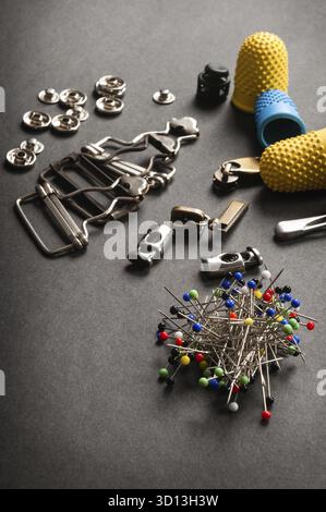 Thimble and sewing pins on dark backdround Stock Photo