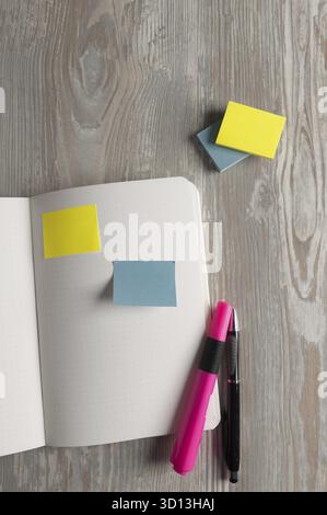 Notebook with pen and sticky notes on wood table Stock Photo