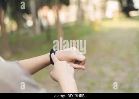 Woman using smart watch in the outdoor Stock Photo