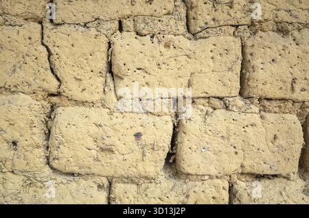 Old yellow mud brick wall background with good texture Stock Photo