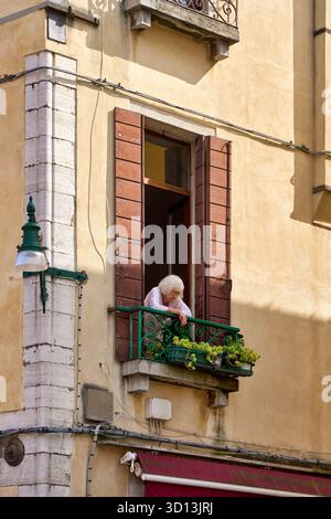 Lady looking out a window, Venice, Venezia, Veneto, Italy, Europe Stock Photo