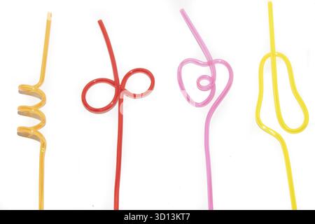 Colored straws for cocktail isolated on white background. To drink a cocktail. colored plastic food. Decorating a glass with a cocktail. Beverages Stock Photo