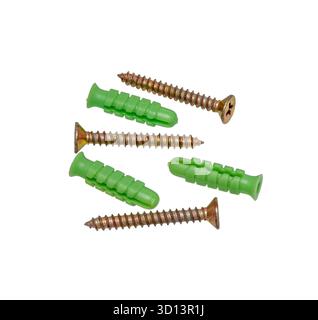Screws and plastic dowels on white background. Stock Photo