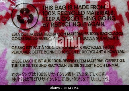 This bag is made from 100% recycled materials. Keep a good thing going by recycling it again. - in many different languages Stock Photo