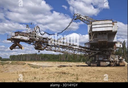 Big dredge on sandy open-cast mine against the sky Stock Photo