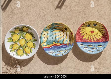 Scicli, Sizilien - Italy - 04-05-2025: Three colorful ceramic plates on a wall in Scicli, featuring lemons and artistic sun designs with vibrant patte Stock Photo