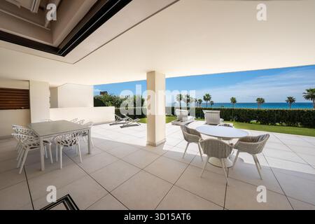 Outdoor patio with dining area and ocean view along the mediterranean Stock Photo