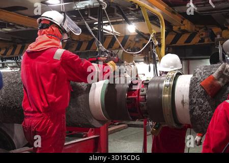 Welding the pipeline for laying on the seabed. Work in a pipe-layer Stock Photo