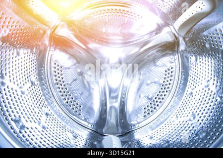 Inside the drum of the washing machine. Steel drum open. Closeup. washing machine drum background with copyspace showing household concept. texture Stock Photo