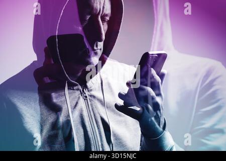 Double exposure of man in hoodie using smartphone, creative concept symbolizing technology, connection, and digital identity. Selective focus. Stock Photo
