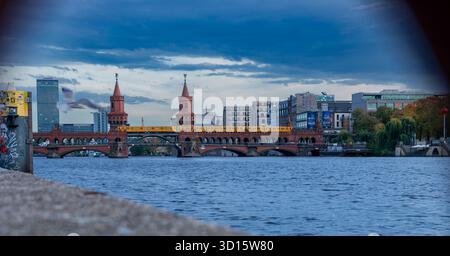 The Oberbaum Bridge (Oberbaumbrücke) in Berlin, Germany, captured from the Spree River through a metal mooring ring. Stock Photo