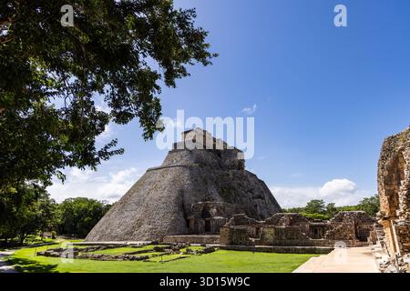 Pyramid of the Magician surrounded by ancient Maya structures at Uxmal, Yucatán, Mexico. Stock Photo