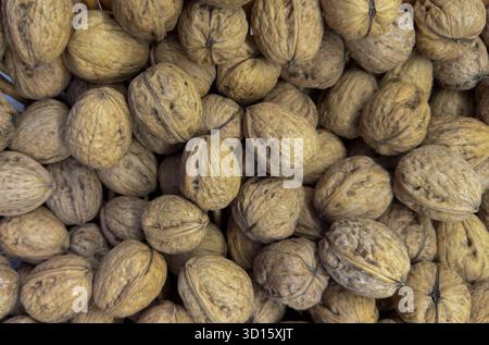 Whole walnuts in shell showing organic texture and earthy brown tones Stock Photo