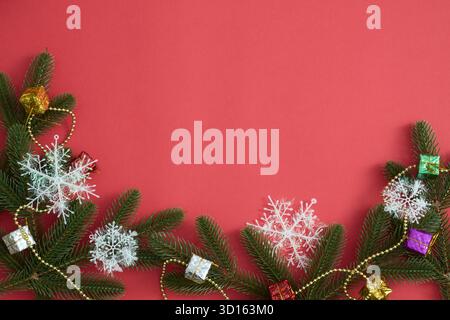Christmas decorations: snowflakes, spruce branches, pinecones on red festive background Stock Photo