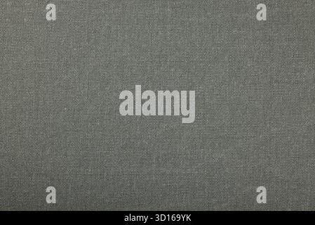 Gray canvas textile surface providing a textured background, highlighting the uniform woven pattern and creating a versatile backdrop for various desi Stock Photo