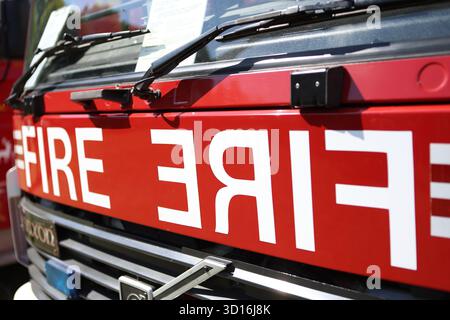 Fire lettering painted in reverse on front of fire engine Stock Photo ...