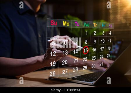 Calendar planning concept. Person using stylus to mark on virtual calendar, representing appointment scheduling, time management, event reminder, Stock Photo