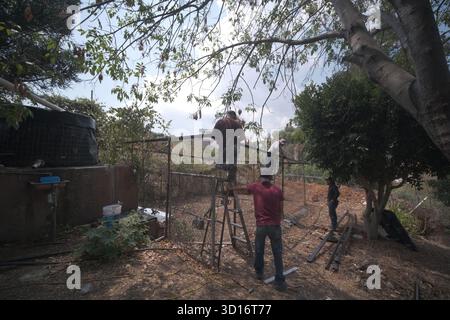 Blacksmiths working outdoors on a very simple structure Stock Photo