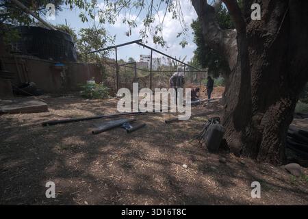 Blacksmiths working outdoors on a very simple structure Stock Photo