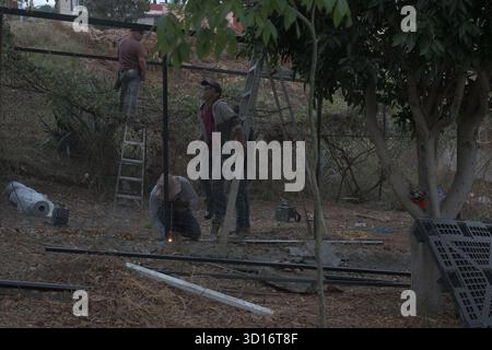 Blacksmiths working outdoors on a very simple structure Stock Photo