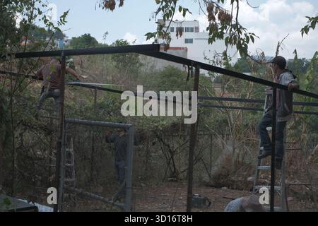 Blacksmiths working outdoors on a very simple structure Stock Photo