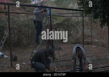 Blacksmiths working outdoors on a very simple structure Stock Photo