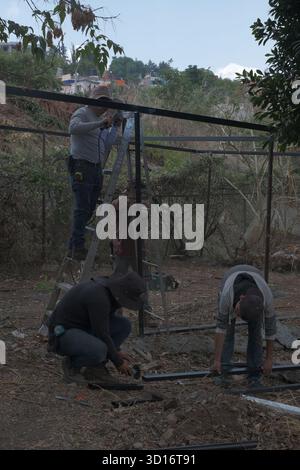Blacksmiths working outdoors on a very simple structure Stock Photo