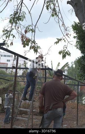 Blacksmiths working outdoors on a very simple structure Stock Photo