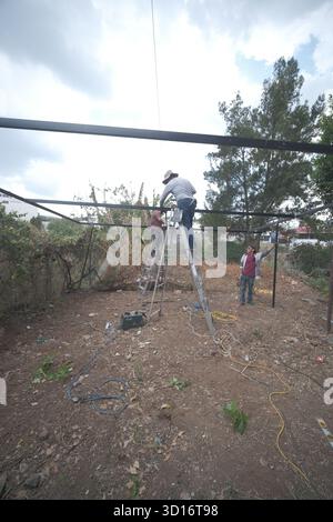 Blacksmiths working outdoors on a very simple structure Stock Photo