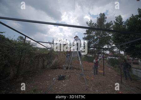 Blacksmiths working outdoors on a very simple structure Stock Photo