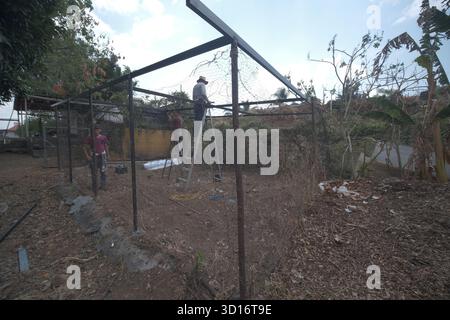 Blacksmiths working outdoors on a very simple structure Stock Photo