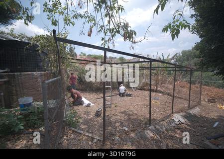 Blacksmiths working outdoors on a very simple structure Stock Photo