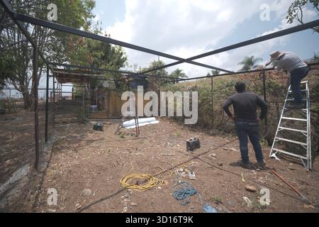 Blacksmiths working outdoors on a very simple structure Stock Photo