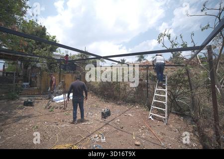 Blacksmiths working outdoors on a very simple structure Stock Photo