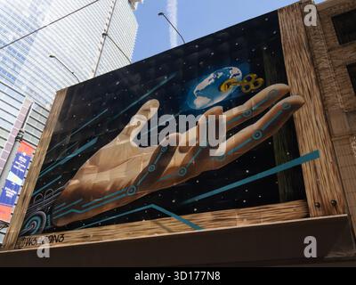 W3R3ON3 mural entitled "Innovation for All" in Houston, TX. It shows a hand grasping for the earth with a key and is about access to technology and in Stock Photo